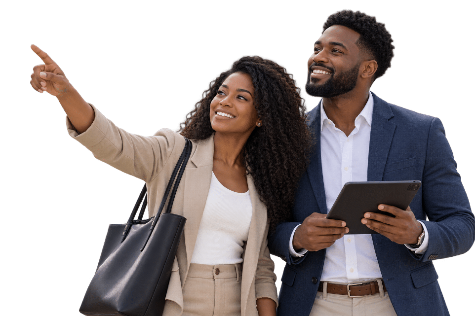 Professional couple smiling and pointing toward a property while holding a digital tablet.
